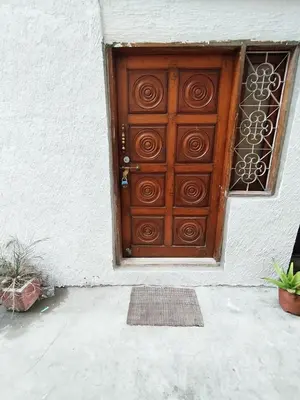 a wooden door on the side of a building at Mysore City Vibe By A1k in Mysore