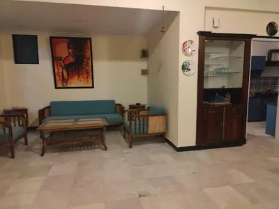 a living room with a blue couch and a table at 3 BHK Flat for rent at Mysuru in Mysore