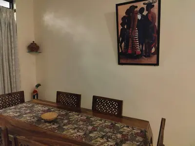 a dining room with a table and a picture on the wall at 3 BHK Flat for rent at Mysuru in Mysore