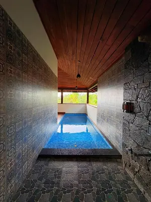a swimming pool in the middle of a room at Calithra Boutique Resort in Chithragiri