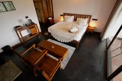 a bedroom with a bed and a table and chairs at Calithra Boutique Resort in Chithragiri