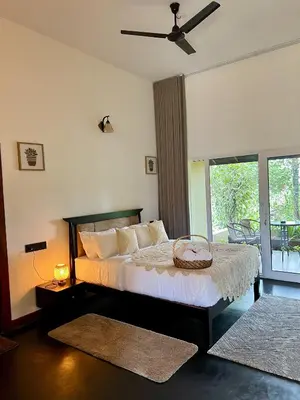 a bedroom with a bed with a basket on it at Calithra Boutique Resort in Chithragiri
