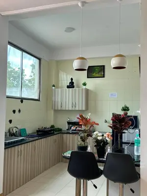 a kitchen with a table and chairs in it at SKYRIN Bliss in Mysore