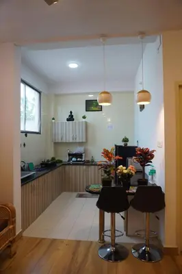 a kitchen with a table and chairs in a room at SKYRIN Bliss in Mysore