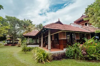 a house with a porch in a yard at Madilina Heritage Villa in Parūr