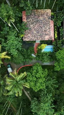 an overhead view of a house with a pool and trees at Mcafe Private Pool Plantations by Greenescapes in Kenichira