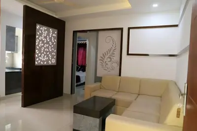 a living room with a couch and a table at Ambalath whitespring in Guruvāyūr