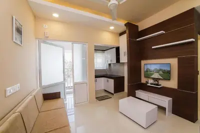 a living room with a couch and a tv at Ambalath whitespring in Guruvāyūr