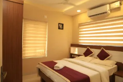 a bedroom with a bed and a window at Ambalath whitespring in Guruvāyūr