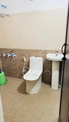 a bathroom with a toilet and a sink at SGH Mysore dorm bus rail station in Mysore
