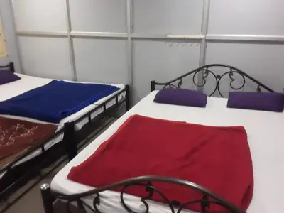 a room with two beds in a roomthritisthritisthritisthritisthritisthritisthritisthritis at SGH Mysore dorm bus rail station in Mysore