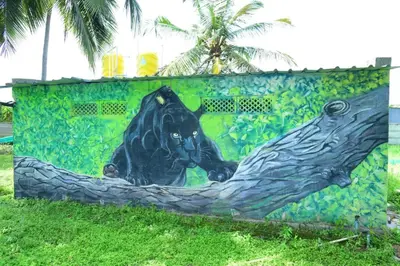 a painting of a black bear on a wall at Lucky Escape Adda in Hullahalli