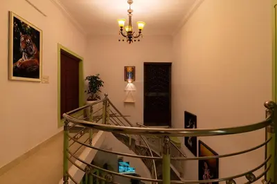a spiral staircase in a home with a chandelier at GEE DE Homes in Kizhake Chālakudi