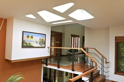 a room with a staircase with a painting on the wall at Midtown Meadow in Kozhikode