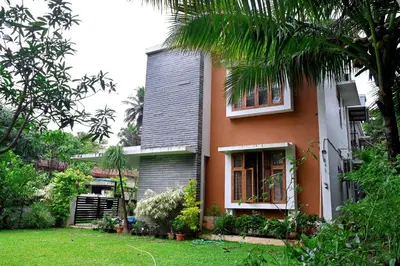 a house with a garden in front of it at Midtown Meadow in Kozhikode