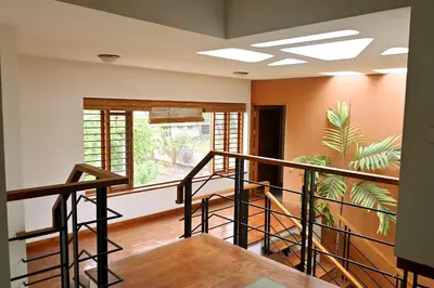 a room with a staircase and a window at Midtown Meadow in Kozhikode