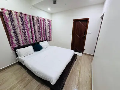 a small bedroom with a bed and a window at LUXE Premium Service Appartment in Mysore
