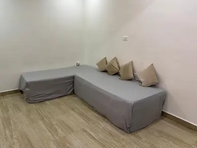 a bed with four pillows on it in a room at LUXE Premium Service Appartment in Mysore