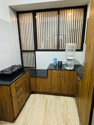 an empty kitchen with a glass bowl on a counter at LUXE Premium Service Appartment in Mysore