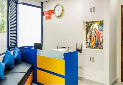 a room with a counter and a clock on the wall at Ambadi Blueberry in Guruvāyūr