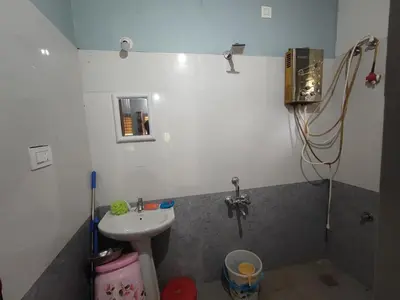 a small bathroom with a sink and a shower at Mountain View Stay in Kushālnagar