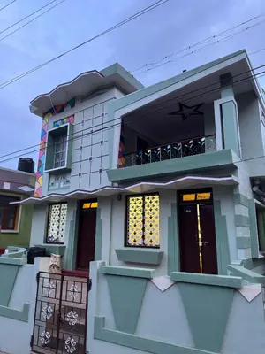 a small house with a balcony and doors at JMS Holiday homes in Coonoor