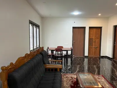 a living room with a couch and a table at Away From Home - 8 - HomeStay, Entire 2 BHK Villa in Ooty