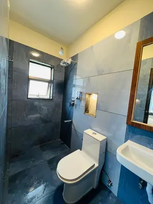 a bathroom with a toilet and a sink at Away From Home - 8 - HomeStay, Entire 2 BHK Villa in Ooty