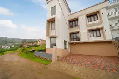a large white house with a driveway at Away From Home - 9 - HomeStay, Entire 2 BHK Villa in Ooty