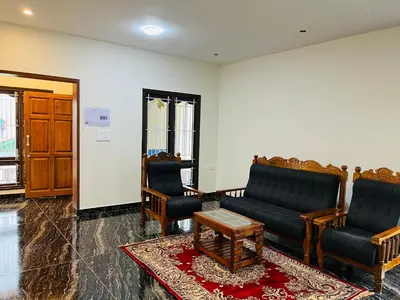 a living room with two couches and a coffee table at Away From Home - 9 - HomeStay, Entire 2 BHK Villa in Ooty