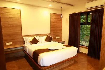 a bedroom with a large bed with a window at Swiss Holidays in Pinangode