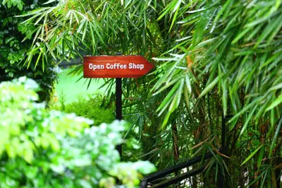 a sign that says open office shop in a garden at Swiss Holidays in Pinangode