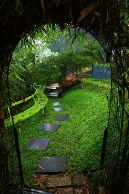 a park with a bench and a walkway at Swiss Holidays in Pinangode