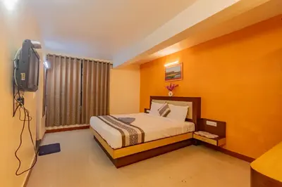 a bedroom with a bed and a television in it at A Ooty Garden Residency in Ooty