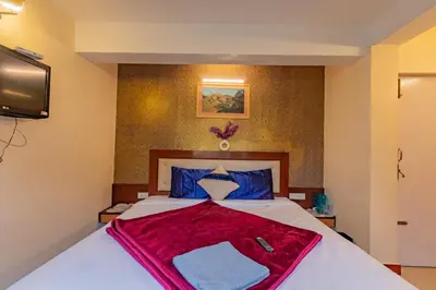 a bedroom with a bed with a red blanket on it at A Ooty Garden Residency in Ooty