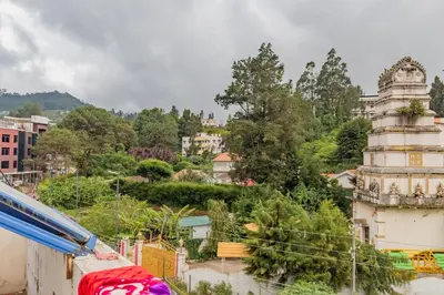 a view of a city with buildings and trees at A Ooty Garden Residency in Ooty