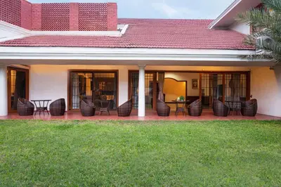 a patio with chairs and tables on a house at Dwaraka inn -Premium Pool villa and event venue in Coimbatore