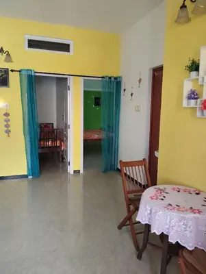 a living room with a table and a chair at A Cozy Homestay in Coimbatore in Coimbatore