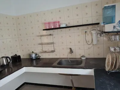 a kitchen with a sink and a counter top at A Cozy Homestay in Coimbatore in Coimbatore