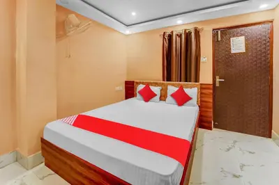 a bedroom with a bed with red pillows at Hotel O Sulur Bus Terminal Formerly Sri Sakthi Vinayagar Residency