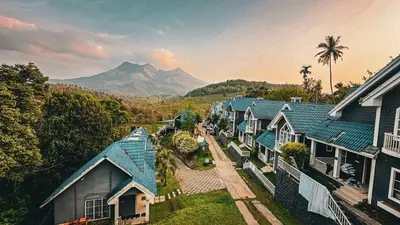 an overhead view of a row of houses with mountains in the background at Aura 2Bedroom Duplex Villa with infinity pool in Kalpetta