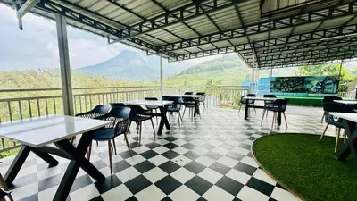 a restaurant with tables and chairs on a checkered floor at Aura 2Bedroom Duplex Villa with infinity pool in Kalpetta