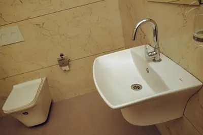 a bathroom with a sink and a toilet at Wood Clusters in Suntikoppa