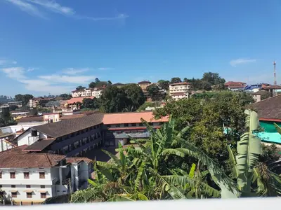 a view of a city with buildings and trees at Laali Penthouse in Madikeri