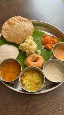 a plate of food with different types of food on it at Laali Penthouse in Madikeri