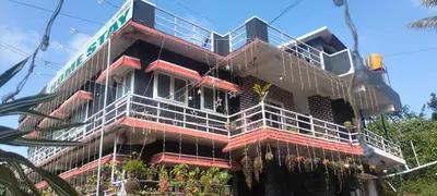 a building with scaffolding on the side of it at Laali Dormitory in Madikeri