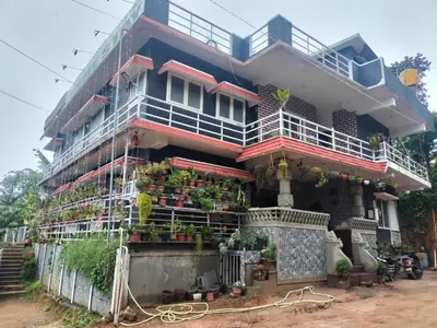 a building with a lot of plants on it at Laali Dormitory in Madikeri