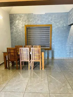 a dining room with a table and four chairs at The Soul 1 Service Villa in Mananthavady