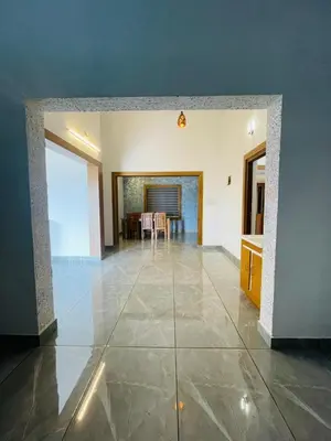 a living room with a table and a dining room at The Soul 1 Service Villa in Mananthavady
