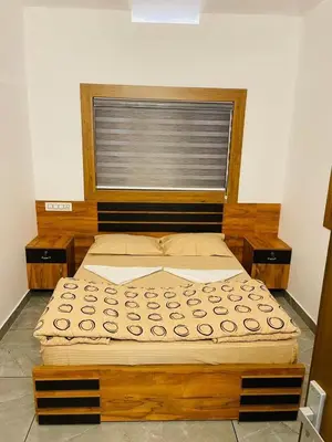 a large bed in a room with a window at The Soul 1 Service Villa in Mananthavady